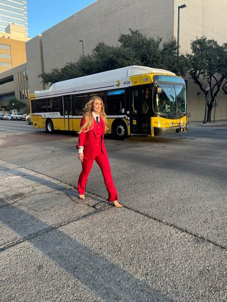 tanya ragan in front of a bus in dallas square